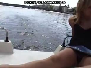 Platin-blondine gurgelt meatpipe auf einem boot im gesamtblick der stadt